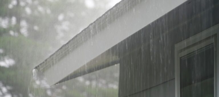 photo of the edge of a roof during rain