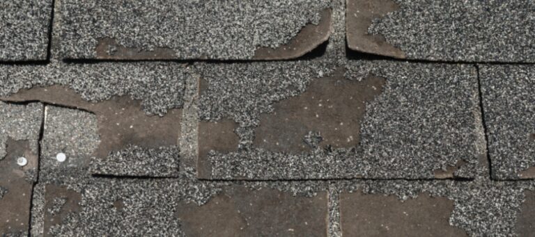 old asphalt shingles, cracked and peeling off the roof